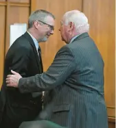  ?? ?? Holihan and former Lehigh County District Attorney Jim Martin shake hands after the ceremony.