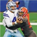  ?? RON JENKINS/ASSOCIATED PRESS ?? Dallas Cowboys quarterbac­k Dak Prescott is sacked Sunday by Cleveland Browns defensive end Myles Garrett.