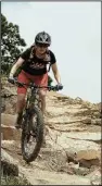  ??  ?? Amber Brown, project manager for the Arkansas Parks and Recreation Foundation, rides a long downhill at Mount Nebo State Park.