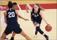  ?? Kathy Willens / Associated Press ?? UConn guard Paige Bueckers (5) drives around
St. John’s guard Kadaja Bailey as UConn forward Olivia Nelson-Ododa (20) keeps Bailey from Bueckers during the second quarter of an NCAA women’s basketball game on Feb. 17 at St. John’s University in New York.