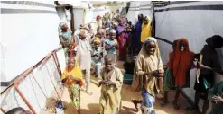  ??  ?? People stand between tents at the internally displaced persons’ camp in Anka.