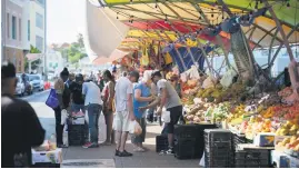  ?? ?? COLOURFUL PALETTE. People buy vegetables and fruit at the Punda floating market on the waterfront of old town Willemstad, Curacao, in the Dutch Caribbean.