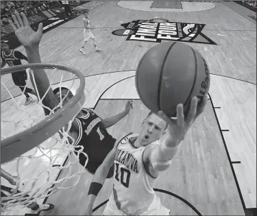  ?? Associated Press ?? To the hoop: Villanova's Donte DiVincenzo (10) goes up for a shot against Michigan. DiVincenzo was the surprise star of the NCAA championsh­ip game for Villanova, then became a surprise NBA draft entrant.