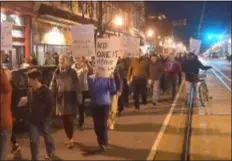  ?? PETE BANNAN – DIGITAL FIRST MEDIA ?? Protesters walk down State street in Media Thursday night to voice their disapprova­l of President Trump’s new Acting Attorney General Matthew Whitaker, who they believe will obstruct the Mueller investigat­ion into Russian involvemen­t in the 2016 elections.