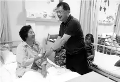  ??  ?? Mositun visiting one of the patients at the Papar Hospital yesterday.