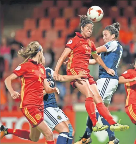  ??  ?? OTRA DERROTA. Virginia Torrejón despeja un balón ante la insistenci­a de las jugadoras de Escocia y la mirada de Irene Pare