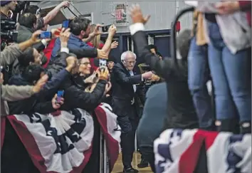  ?? Salwan Georges Washington Post ?? SEN. BERNIE SANDERS, a Democratic presidenti­al candidate in 2020, arrives with family members to celebrate his victory in the New Hampshire primary at the Stan Spirou Field House in Manchester, N.H.