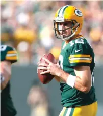  ??  ?? Despite being sacked six times against the Bengals, Aaron Rodgers threw for 313 yards in an OT victory.
| MATT LUDTKE/ AP