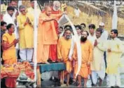  ?? PTI ?? UP chief minister Yogi Adityanath pours milk in the Saryu river during a prayer ceremony at Ayodhya on Wednesday.