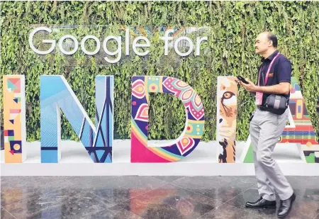  ?? SANKALP PHARTIYAL REUTERS ■ ?? A man walks past the sign of “Google for India,” the company’s annual technology event in New Delhi, India in this Sept. 19, 2019 file photo.