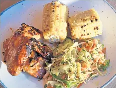  ??  ?? Fresh cabbage-herb slaw and sweet grilled corn are the perfect balance to the spicy piri-piri chicken.