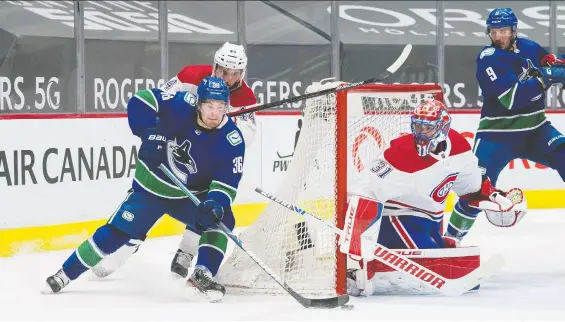  ?? BOB FRID/USA TODAY SPORTS ?? Canucks forward Nils Hoglander goes for the wraparound attempt on Canadiens goaltender Carey Price during Monday's showdown at Rogers Arena.