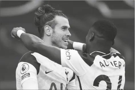  ?? ASSOCIATED PRESS ?? TOTTENHAM’S GARETH BALE (centEr) celebrates with Tottenham’s Serge Aurier after scoring his side’s fourth goal during an English Premier League match between Tottenham Hotspur and Burnley at the Tottenham Hotspur Stadium in London, England, on Sunday.