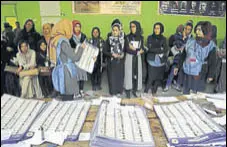  ?? AP ?? Afghan election workers count ballots during the parliament­ary elections at a polling station in Kabul on Sunday.