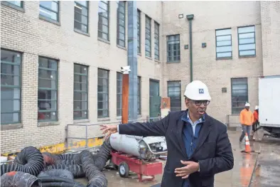  ??  ?? Jimmie Tucker guides a tour of the renovation to the Universal Life Insurance building on March 16. BRAD VEST / THE COMMERCIAL APPEAL