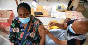 ?? AFP via Getty Images/Phill Magakoe ?? On the front line: A health-care worker receives a dose of the J&J vaccine at Klerksdorp Hospital on February 18
