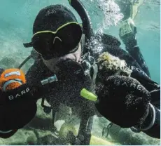  ?? — Clean up The Lake/AP ?? Diver Colin West showing debris found in Lake tahoe from an initial dive in 2020.