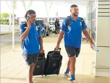  ?? Picture: REINAL CHAND ?? Fijian Drua players Isikeli Rabitu (left) and Emosi Tuqiri arrive at the Nadi Internatio­nal Airport yesterday.
