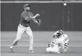  ?? J. MERIC/GETTY IMAGES ?? Shortstop Jose Reyes of the Toronto Blue Jays turns a double play as Jose Lobaton of the Tampa Bay Rays slides during their game Friday night in St. Petersburg, Fla.