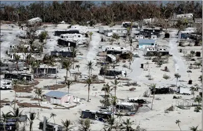  ?? AP/South Florida Sun-Sentinel/MIKE STOCKER ?? This aerial photo taken Wednesday shows widespread damage to homes in Sunshine Key, Fla.