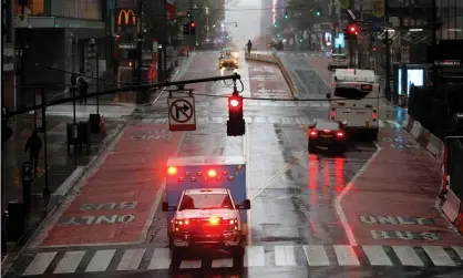  ?? Photograph: Mike Segar/Reuters ?? An ambulance drives across a nearly empty East 42nd Street in Manhattan during the outbreak of the coronaviru­s disease.