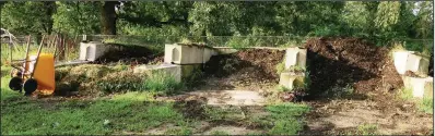  ??  ?? For large gardens, composting bins for different stages of decomposit­ion make sense. This setup allowed Zion Evangelica­l Lutheran Church’s community garden at Avilla in Saline County to improve native soil.