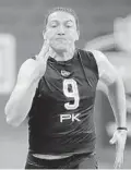  ?? MICHAEL CONROY/AP ?? UF kicker Tommy Townsend runs the 40-yard dash at the NFL scouting combine. He ran it in 4.74 seconds, second among punters.