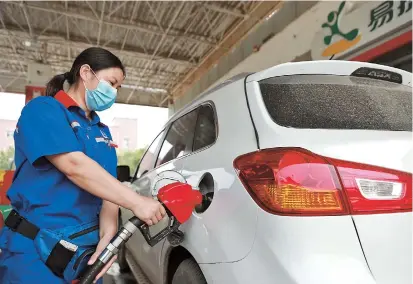  ??  ?? Staff at a gas station refuel vehicles in Xingtai City, north China’s Hebei Province. China will raise the retail prices of gasoline and diesel from today, the country’s top economic planner said yesterday.
Gas prices will go up 120 yuan (US$17) per ton, while diesel will increase 110 yuan per ton, the National Developmen­t and Reform Commission said. It is the first hike for oil prices this year. — Xinhua