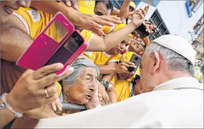  ??  ?? In this Jan. 20, 2018 photo, Pope Francis greets a blind woman after blessing her as he toured around the Plaza de Armas, in Trujillo, Peru earlier this month. Francis consoled Peruvians who lost their homes and livelihood­s in devastatin­g floods last...