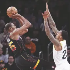  ?? DARRYL WEBB/AP ?? PHOENIX SUNS’ KEVIN DURANT (LEFT) looks to shoot over Utah Jazz’s John Collins (right) during the first half of a game in Phoenix on Thursday.