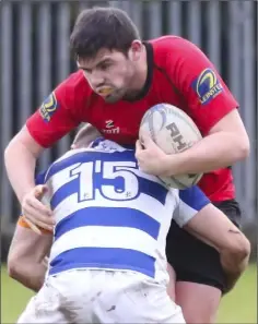  ??  ?? Seán Crowdle ships a strong tackle from the Athy full-back.