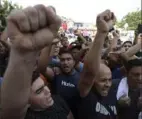  ?? Fernando Vergara/Associated Press ?? Protesters near Cucuta, Colombia, including former members of the Venezuelan Bolivarian National Guards, shout slogans Tuesday against Venezuela’s President Nicolás Maduro.