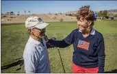  ?? Bobby Block/The Signal ?? (Above) Nancy Butler greets one of the veterans attending the “Thank-a-Vet” golf event held at the Sand Canyon Country Club. (Below) Doug Kendall shows one of the veterans attending the “Thank-a-Vet” golf how to operate an air cannon during the tribute event.