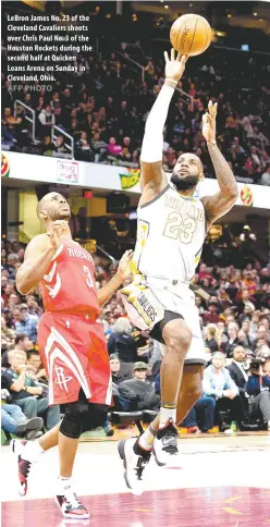  ?? AFP PHOTO ?? LeBron James No. 23 of the Cleveland Cavaliers shoots over Chris Paul No. 3 of the Houston Rockets during the second half at Quicken Loans Arena on Sunday in Cleveland, Ohio.