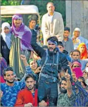  ?? WASEEM ANDRABI/HT ?? An unknown ‘militant’ is seen during the funeral procession of Hizbul Mujahideen commander Sabzar Ahmed Bhat at Ratsuna village in Tral, near Srinagar, on Sunday. His appearance created a commotion among the locals, who claimed he had escaped from the...