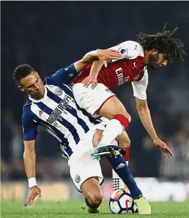  ?? — AP ?? Money spinner: West Bromwich Albion’s Kieran Gibbs (left) with Arsenal’s Mohamed Elnenar during their English Premier League soccer match at the Emirates stadium in London on Monday.