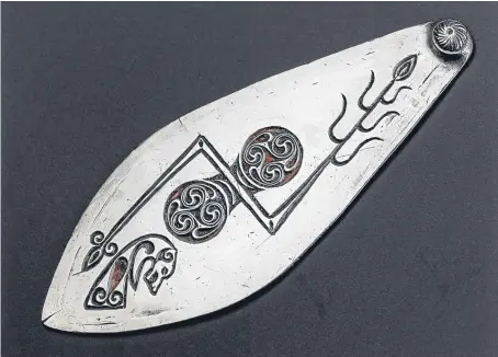  ?? Picture: Saltire News. ?? The teardrop-shaped piece of silver is thought to have been part of a Pictish helmet like that shown below.