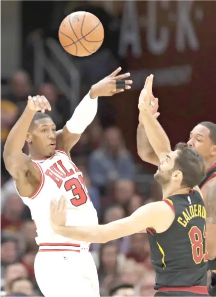  ?? | AP ?? Bulls point guard Kris Dunn, guarded by Cavaliers guard Jose Calderon, had 10 points and 14 assists Thursday night in Cleveland.