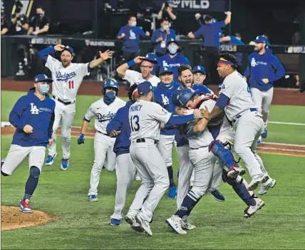  ?? THE DODGERS Wally Skalij Los Angeles Times ?? celebrated their first World Series crown since 1988 but the title was won thousands of miles away in Arlington, Texas, where most fans could not attend because of coronaviru­s restrictio­ns. No parade followed for the same reason.