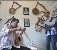  ?? KHALED DESOUKI / AFP ?? Egyptian craftsman Mohamed Ghaly adds finishing touches to a semsemia harp that he made at a cultural museum in Port Said, Egypt, on May 29.