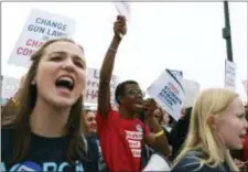  ?? ANDREA CORNEJO — LAS VEGAS REVIEW-JOURNAL VIA AP ?? Markell Merritt, a 15-year-old student from Legacy High School, center, participat­es in the Las Vegas March for Our Lives event, which started at Symphony Park and ended in Las Vegas City Hall, on Saturday.