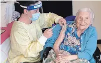  ?? PETERBOROU­GH PUBLIC HEALTH PHOTO ?? Elizabeth Campbell receives her COVID-19 shot Tuesday from Lori Rowsell, infection prevention and control practition­er at Fairhaven. It’s the first local home to get the Moderna vaccine.