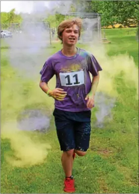  ?? DIGITAL FIRST MEDIA FILE PHOTO ?? A student emerges from a cloud during a color run fundraiser at West-Mont Christian Academy in North Coventry.