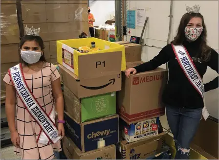  ?? SUBMitteD Photo ?? Boyertown 4th grader Sydney gonzalez, left, has been crowned Miss Pennsylvan­ia elementary. Pictured working with fellow queen Mallie Mcnicholas on a canned food drive for helping harvest, gonzalez will compete for the national title in July.