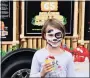  ?? JESI YOST - FOR MEDIANEWS GROUP ?? After having her face painted as a Dalmatian, Quinn Smitley, 8, tries a Kona Ice at a Pottstown Hospital – Tower Health Community Festival food truck.