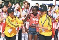  ?? ZHANG CHENLIN / XINHUA ?? Kenya’s Valary Aiyabe beams with pride after becoming the first female runner to finish the Beijing Marathon 2018 on Sunday.