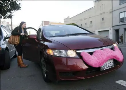  ?? THE ASSOCIATED PRESS ?? Lyft passenger Christina Shatzen gets into a car driven by Nancy Tcheou on Jan. 4, 2013, in San Francisco. Within five years, a majority of ride-hailing company Lyft’s rides will be in self-driving cars, the company’s co-founder and president predicted.