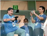  ?? GETTY IMAGES ?? Argentine superstar Lionel Messi, left, cuts a dejected figure during the match, while Diego Maradona didn’t look too thrilled with what he saw from the stands as a bystander takes his photo.
