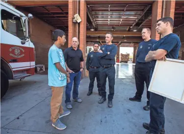  ?? SEAN LOGAN/ THE REPUBLIC ?? Eric Mendez, 14, visits Phoenix Fire Station 5 Wednesday to meet firefighte­rs who responded when he was accidental­ly shot in 2016.