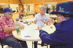  ?? JIM THOMPSON/JOURNAL ?? Ramon Valenzuela, Licho Alderete and Salvador Medina play cards at the Barelas Senior Center.